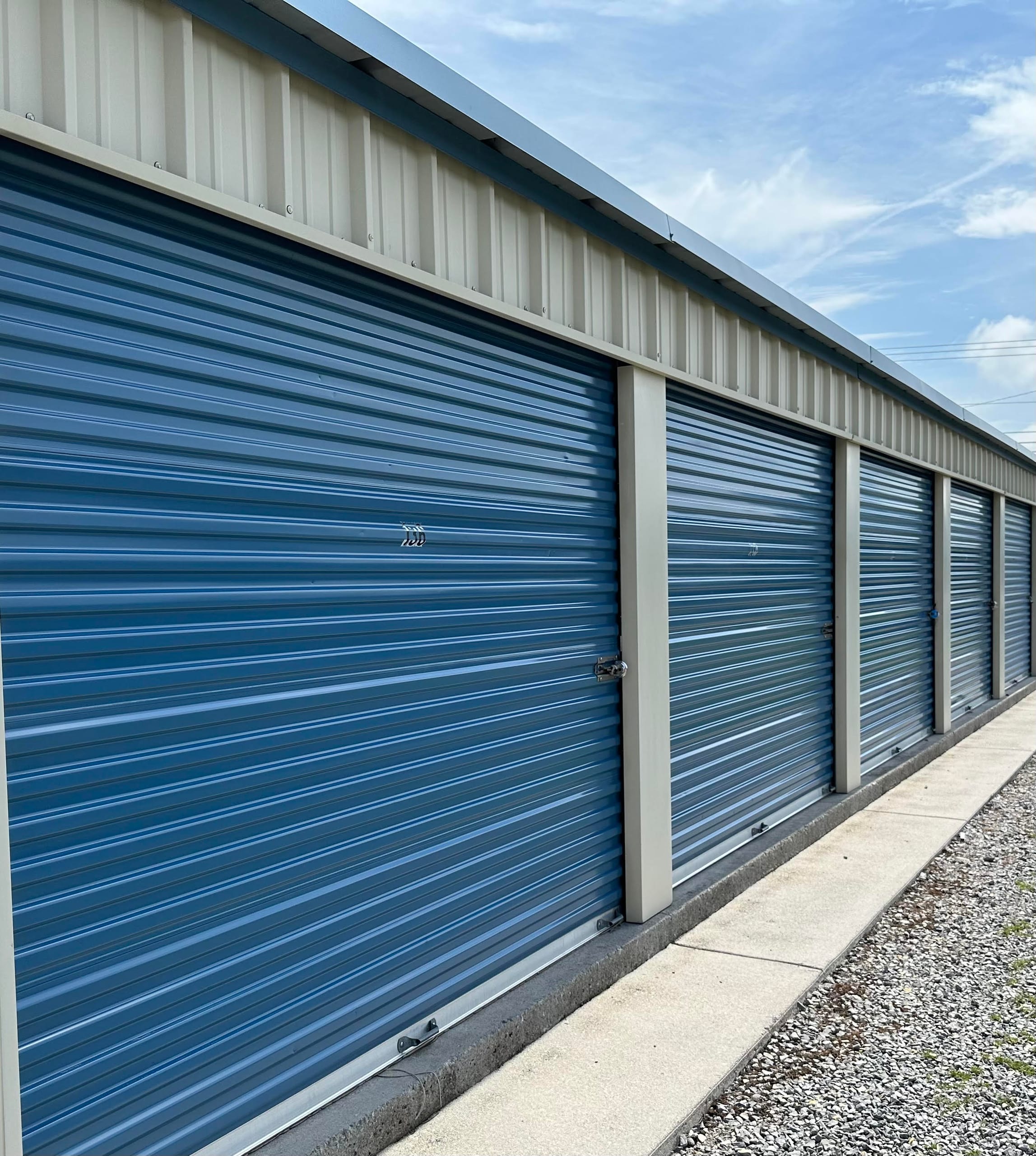 Blue roll-up doors on drive-up storage units at Storage Park Etowah North